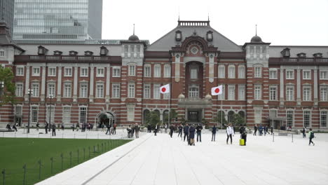 Crowds-of-random-pedestrians-loitering-in-front-of-the-main-entrance-to-the-Tokyo-Train-Station,-Tokyo,-Japan