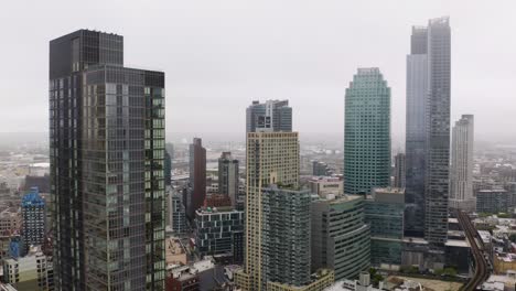 Aerial-Sliding-Shot-Reveals-Skyscrapers-in-Foggy-City