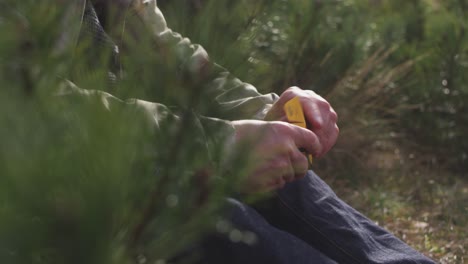 Details-shot-of-a-man-taking-of-his-analog-film-out-of-its-box-and-put-it-into-his-camera