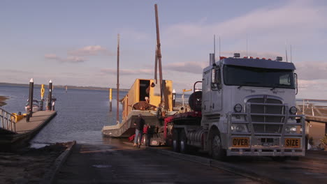 Launching-a-large-dredging-barge-at-a-boat-ramp-time-lapse-from-a-large-semi-trailer