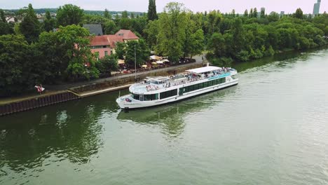 following-a-boat-on-the-sewer-of-Frankfurt-am-Main-Germany,-paning-left