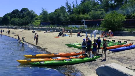 People-line-up-to-get-instructions-on-using-ocean-kayaks