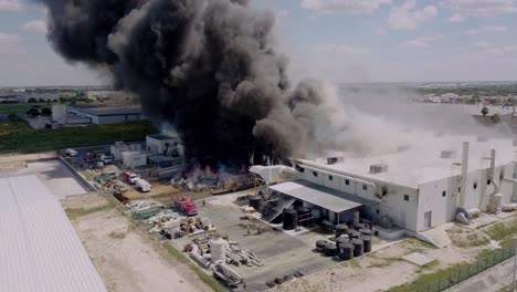 Aerial---textile-factory-fire-in-Reynosa,-Tamaulipas,-Mexico,-wide-circle-shot