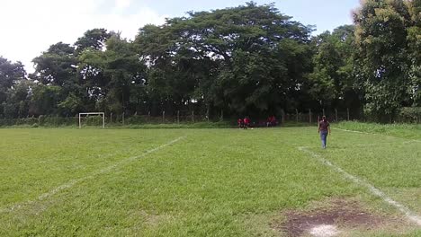 View-of-a-group-of-young-women-in-the-middle-of-a-soccer-training,-recorded-from-a-drone