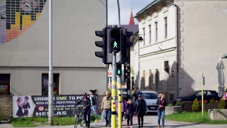 Pedestrians-Waiting-For-The-Traffic-Light-Signal-Before-Crossing-The-Street-In-Slovakia---slow-pan-down