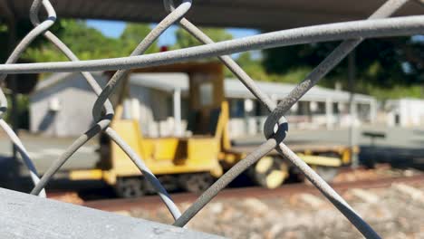 PULL-FOCUS-on-a-Rusty-Old-Yellow-Rail-Rolling-stock-sits-abandoned-in-a-railway-yard---Queensland-Rail