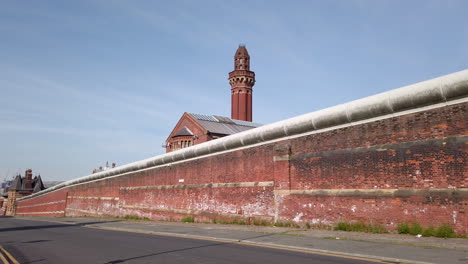Static-Shot-of-Perimeter-Security-Wall-at-HM-Prison-Manchester,-England-a-High-Security-Prison-also-known-as-Strangeways-on-Sunny-Day