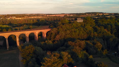 Rising-and-yawing-footage-of-Chapel-viaduct-at-Chapel-in-Essex-and-sunset