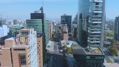 Aerial-flying-in-between-skyscrapers-with-an-almost-empty-road-amid-covid-19-outbreak-on-financial-district-Santiago,-Chile