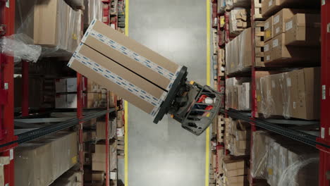 A-forklift-maneuvers-and-elevates-to-place-boxes-on-a-high-shelf-in-a-warehouse