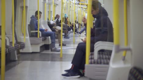 people-on-the-subway,-man-is-sitting-alone-using-his-phone