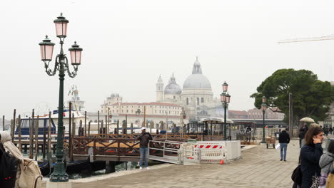 Una-Vista-De-La-Basílica-De-Santa-María-Della-Salute-Desde-El-Muelle-En-Venecia,-Italia