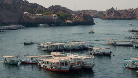 boat-for-touring-guided-trip-moored-at-Aswan-Low-Dam-Lake-Nasser,-Egypt,-travel-destination-for-visiting-the-Philae-temple