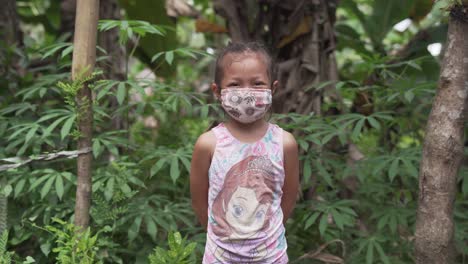 Beautiful-Female-Child-Wearing-Cloth-Mask-Smiling-In-Front-Of-The-Camera---Medical-Concept---medium-shot