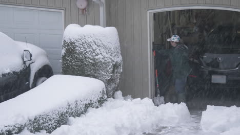 Renton-Washington-resident-shovels-snow-from-her-driveway-during-the-February-13,-2021-snow-storm-in-the-Seattle-Area