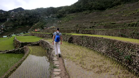 Hiking-man-with-backpack-walks-on-the-Batad's-rice-terraces