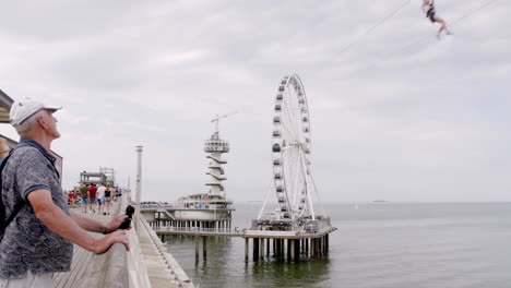 Man-Flying-Fox-From-The-Top-of-Ferris-Wheel-Above-The-Sea