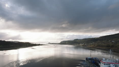 Erskine,-Scotland-beautiful-sunset-over-river-tracking-with-a-working-boat-as-we-pass-it-through-frame