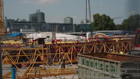 Construction-workers-assembling-cranes-on-building-site-in-Stuttgart-21