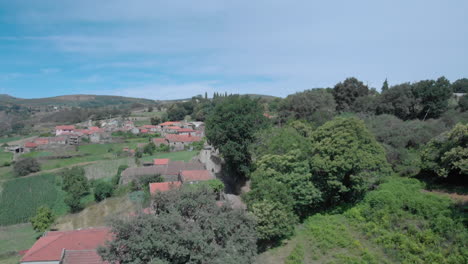 Aerial-tracking-shot-of-a-old-tractor-in-a-rural-village-in-the-north-of-Portugal