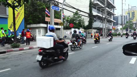 Mopeds-driving-in-the-streets-of-Thailand-during-the-daytime-