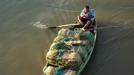 Hombre-Bote-A-Remo-Con-Pies-Vietnam-Vietnamita-Comiendo-Fruta-Día-Río