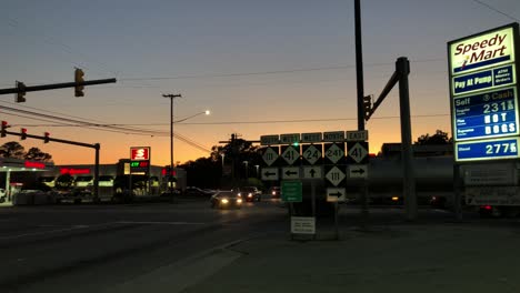 Tanker-truck-crosses-intersection-in-front-of-speedy-mart-gas-station-and-interstate-signs-in-rural-North-Carolina