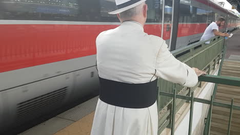 Florence,-Italy---circa-July-2019---Senior-priest-travelling-on-a-local-train-for-pelegrinage