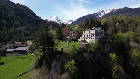 Flying-close-to-Hotel-Schloss-Wartenstein,-Castle-Garden-with-Cristo-Salvador-in-St