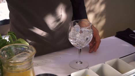 Porto,-Portugal---May-22,-2019:-Professional-bartender-preparing-a-Gin-Tonic-in-table-outside-during-summer