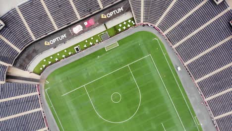 Deserted-Gillette-Stadium-fly-over,-empty-stands-and-vibrant-green-pitch