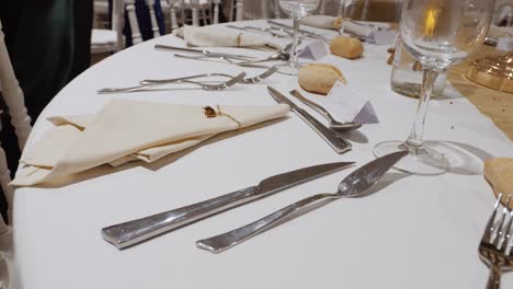 Static-shot-of-tables-set-with-cutlery-ready-for-guests-at-a-wedding