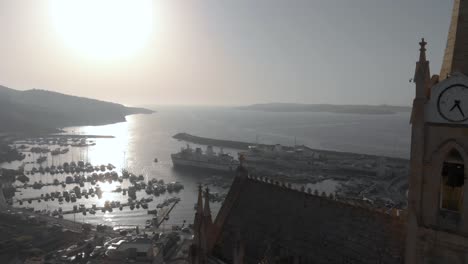 A-drone-fly-by-near-a-very-historical-church-in-Gozo-Island,-a-sister-island-of-Malta-in-the-middle-of-the-Mediterranean