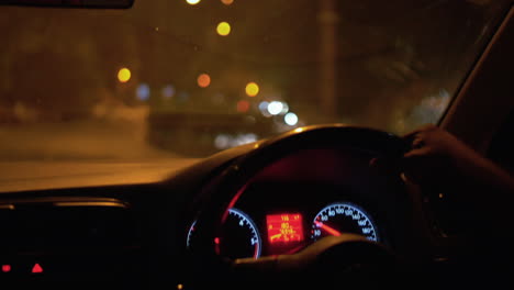 Person-Driving-Car-On-The-Urban-Road-At-Night-In-Delhi,-India---POV-Shot,-Slow-Motion