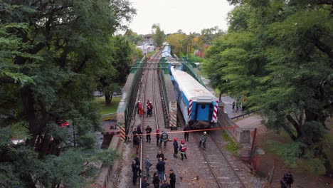 Emergency-workers-at-site-of-train-accident-in-Buenos-Aires,-sinking-aerial
