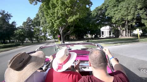 friends-driving-an-old-traditional-classical-red-car-from-cuba-touring-around-the-street-of-havana