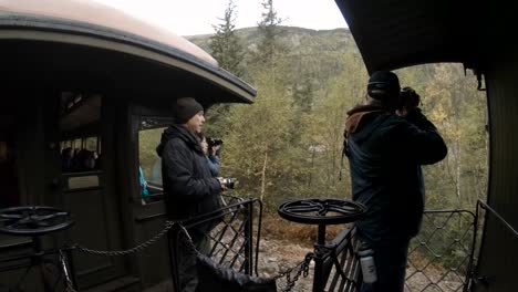 Skagway,-Alaska,-United-States---September-24,-2019:-Photographers-are-taking-pictures-on-the-Old-Historic-Railroad-Train-on-the-way-to-White-Pass