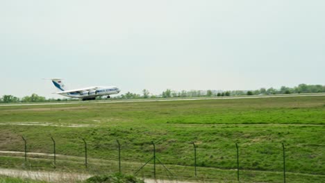 Airplane-landing-on-runway,-pan-right-shot