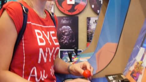 Close-up-of-two-young-people-playing-a-vintage-video-arcade-game-at-the-Cyprus-Comic-Con-in-Nicosia,-Cyprus