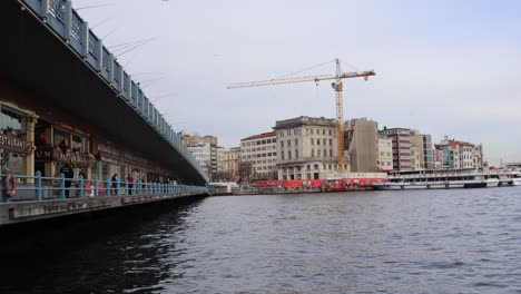 Industrial-Crane-On-Construction-Site-From-Galata-Bridge-Over-Golden-Horn-In-Istanbul,-Turkey