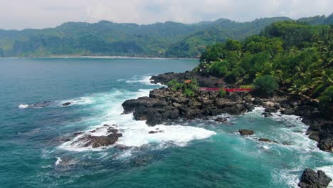Luftaufnahme-Der-Roten-Fußgängerbrücke,-Der-Felsigen-Küste-Und-Des-Menganti-Strandes-In-Indonesien