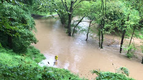 A-flash-flood-caused-by-heavy-rains-overtops-the-banks-of-Rock-Creek-and-inundates-Beach-Drive-in-Rock-Creek-Park,-located-in-Washington,-D