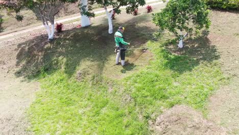 Man-cutting-the-grass-with-a-string-trimmer
