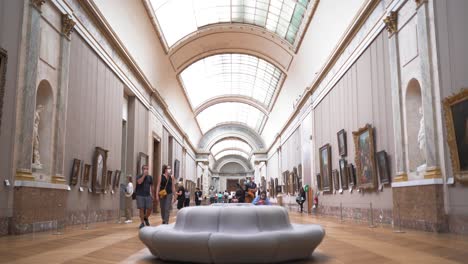 Wide-tilting-shot-of-a-gallery-in-the-Louvre-museum-located-in-Paris