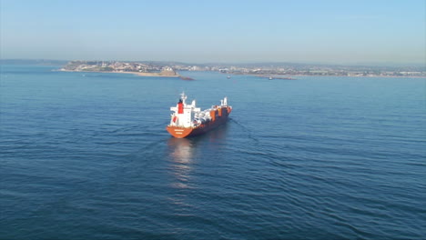 This-video-shows-the-aerial-vision-of-a-container-ship-heading-from-the-sea-into-Newcastle-Harbour,-Australia