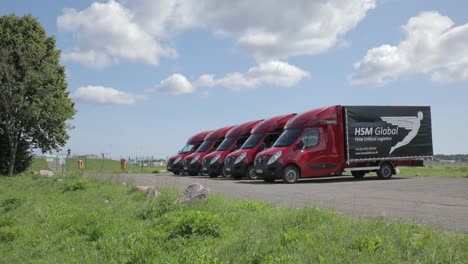 Riser-reveal-shot-of-HSM-Global-delivery-vans-parked-up-next-to-each-other