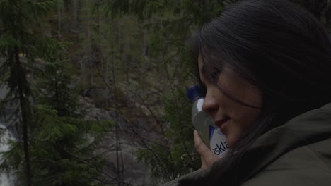 Girl-watching-dramatic-waterfall-in-norway