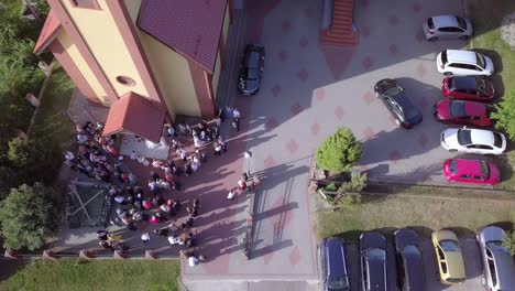 Aerial-shot-of-a-wedding-ceremony-in-a-small-church-on-a-coutryside