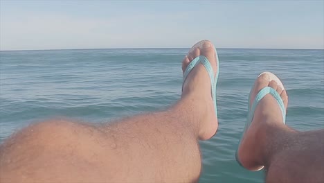 Man-using-a-famous-brazilian-flip-flop-brand-during-a-boat-trip-in-Brazil