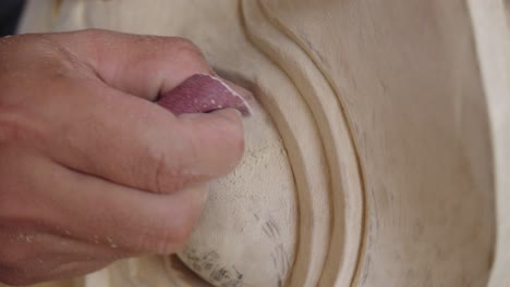 Hand-Sanding-Hand-carved-Barong-Sculpture-With-Sandpaper